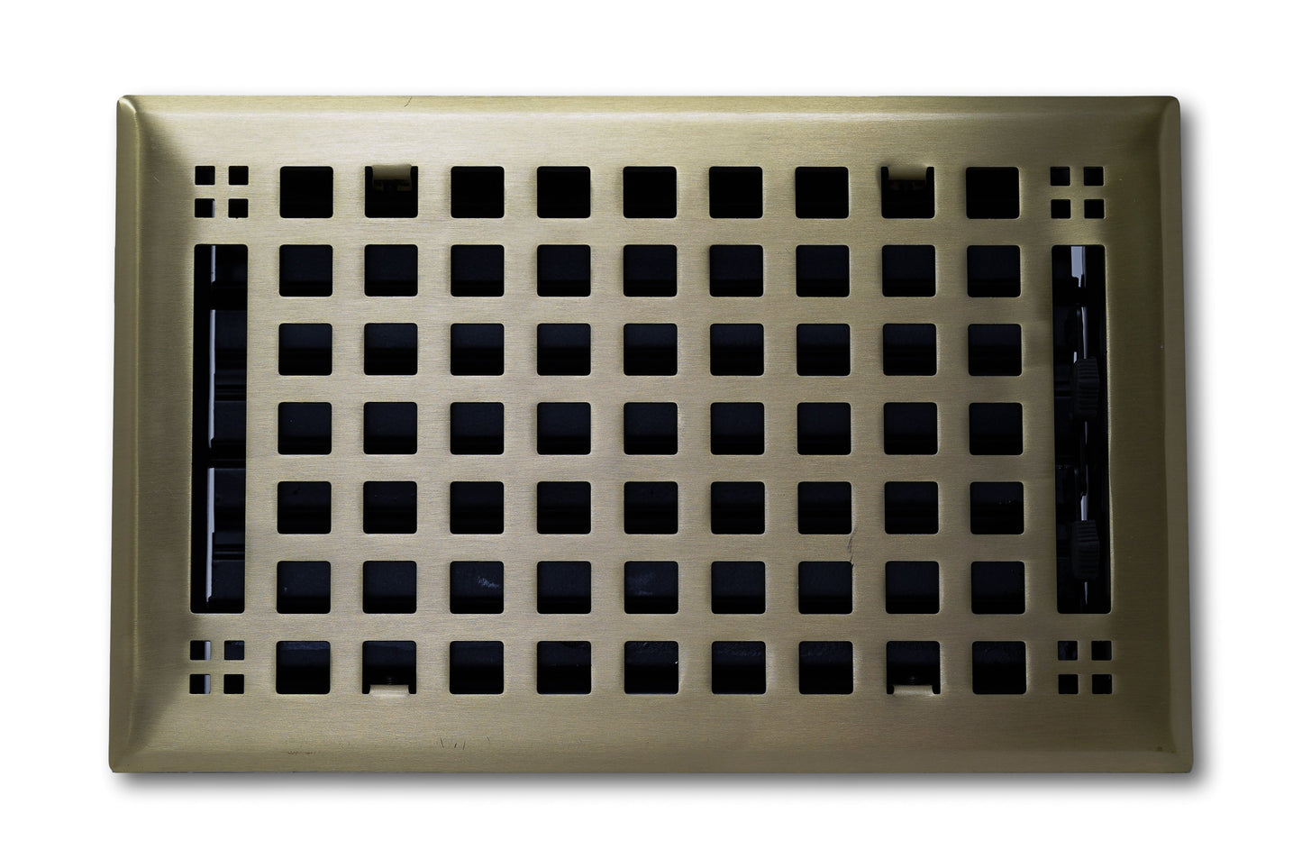 Madelyn Carter Steel Artisan Vent Cover in Antique Brass features a grid of square holes and a decorative border, perfect for floors or walls. Shown from above against a white background.