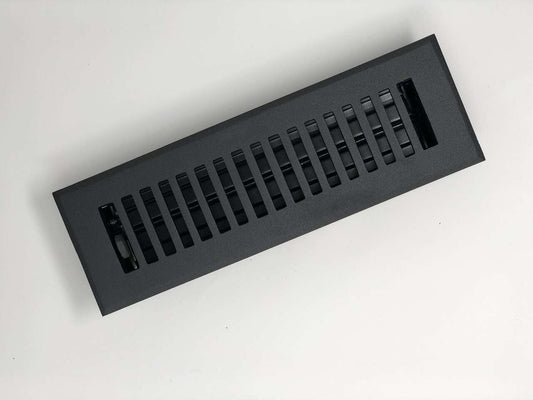 The Madelyn Carter Cast Aluminum Contemporary Vent Cover in black, featuring parallel slats and a modern rectangular design, is shown against a white background, showcasing stylish functionality for updated interiors.