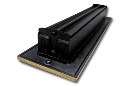 A close-up view of a Cast Aluminum Linear Bar Vent Cover in Antique Brass by Madelyn Carter, mounted on a rectangular base, designed for durability and to seal gaps, much like rust-resistant vent covers.