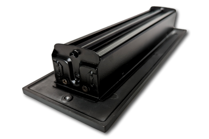 A close-up of a black metal rolling machine on a flat surface, shot at an angle against a white background, evokes the sleek style of Madelyn Carter Cast Aluminum Linear Bar Vent Covers - Black.