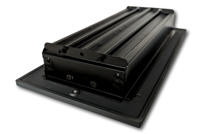 The Madelyn Carter Cast Aluminum Linear Bar Vent Cover in Carbon Gray features a sleek, black rectangular design with rollers on a flat base, photographed against a white background.