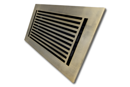 The Madelyn Carter Cast Aluminum Linear Bar Vent Cover in Antique Brass features horizontal slats and a rust-resistant rectangular design, displayed at an angle on a white background.