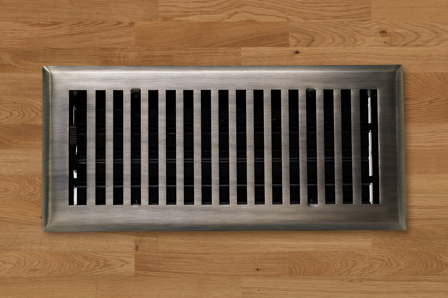 The Madelyn Carter Cast Brass Contemporary Vent Covers in Antique Brass offer a timeless touch with vertical slats, perfect for adding elegance to your wooden floor.
