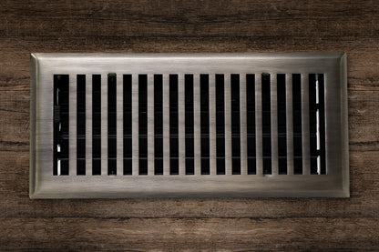 The Madelyn Carter Cast Brass Contemporary Vent Cover in Antique Brass is installed in a wooden surface, providing both functionality and modern style with its vertical metal slats.
