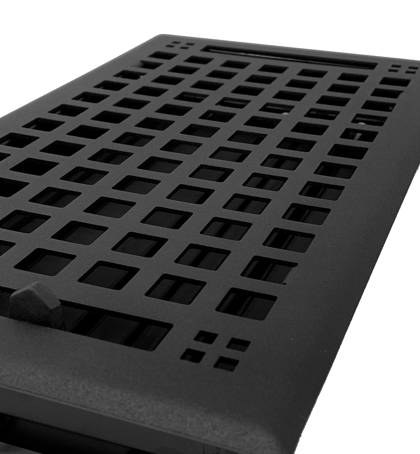Close-up view of the Madelyn Carter Steel Artisan Vent Cover in black, featuring a grid pattern of square openings. Only CSS code and HTML structure are shown—no actual product description text is provided.