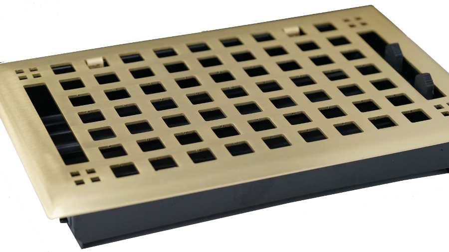 The Madelyn Carter Steel Artisan Vent Cover in Brushed Brass is a rectangular floor vent with a stylish grid design and adjustable black side tabs for easy installation and airflow control.