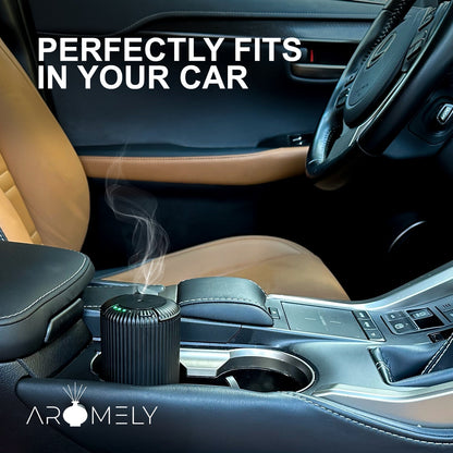 The ARO-CAR by Aromely, a compact black diffuser, emits vapor while fitting perfectly in your car’s cup holder. The phrase “Perfectly fits in your car” appears above, with the AROMELY logo visible in the corner.