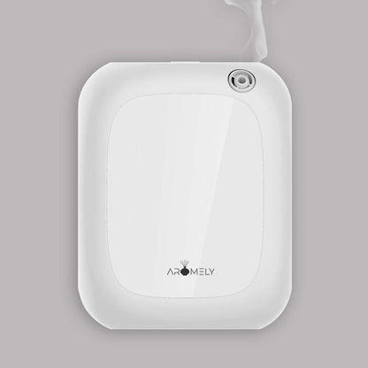 The Aromely Smart Bluetooth Scent Diffuser by AROMELY is a white, wall-mounted device featuring cold diffusion technology and emits a fine vapor from the top right nozzle; suitable for spaces up to 1,500 sqft, shown against a grey background.