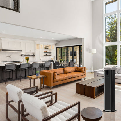 Modern open-concept living room and kitchen featuring a brown leather sofa, white armchairs, bar seating, large windows, a black tower fan, and the AROMELY Aromely Smart Bluetooth Scent Diffuser for up to 2,000 SQSF in the foreground.