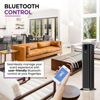 A hand holds a smartphone showing Bluetooth control for the AROMELY Aromely Smart Bluetooth Scent Diffuser, using cold air diffusion in a modern living room with large windows and brown sofas, covering up to 2,000 SQSF (open areas).