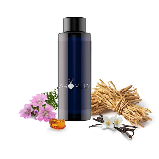 A dark blue bottle labeled "AROMELY Blessed" is surrounded by pink flowers, vanilla pods, dried roots, and amber resin, evoking an oriental floral scent ideal for indulgent aromatherapy.