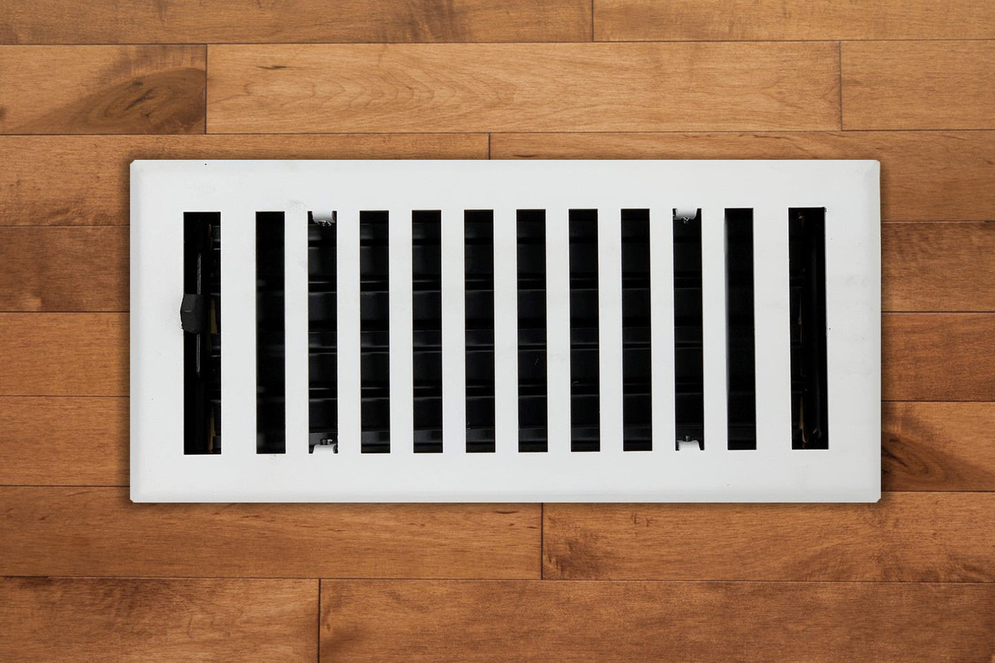 The Madelyn Carter Steel Modern Chic Vent Covers in white feature vertical slats that add a stylish touch to light brown wooden floors.