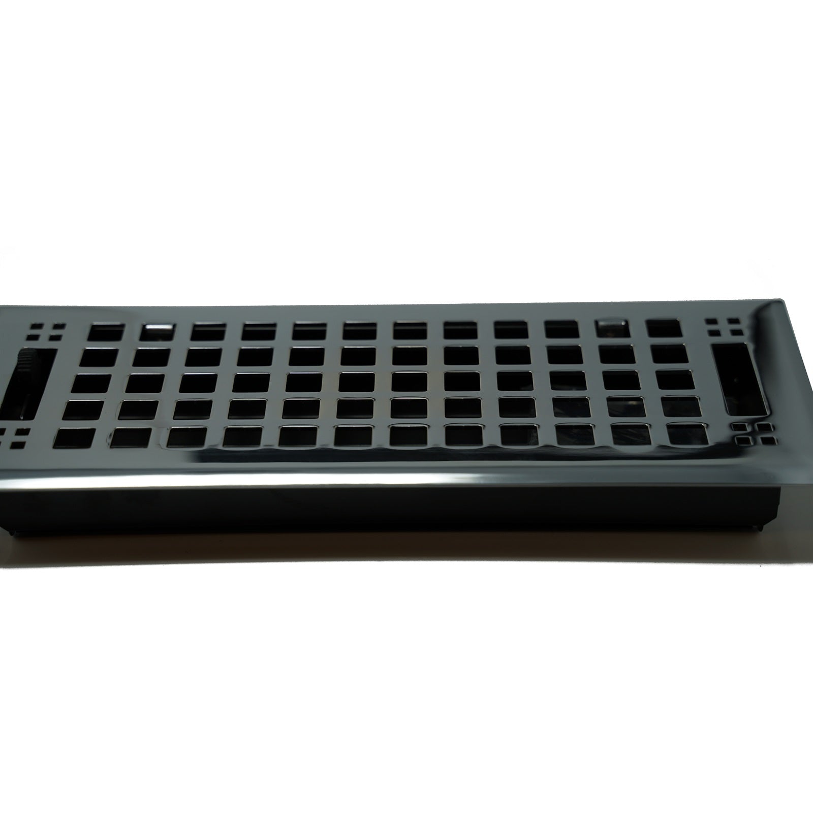 A black mechanical keyboard case without keycaps or switches, featuring the Madelyn Carter Cast Brass Artisan Vent Cover in polished chrome, is shown from a side angle on a white background.