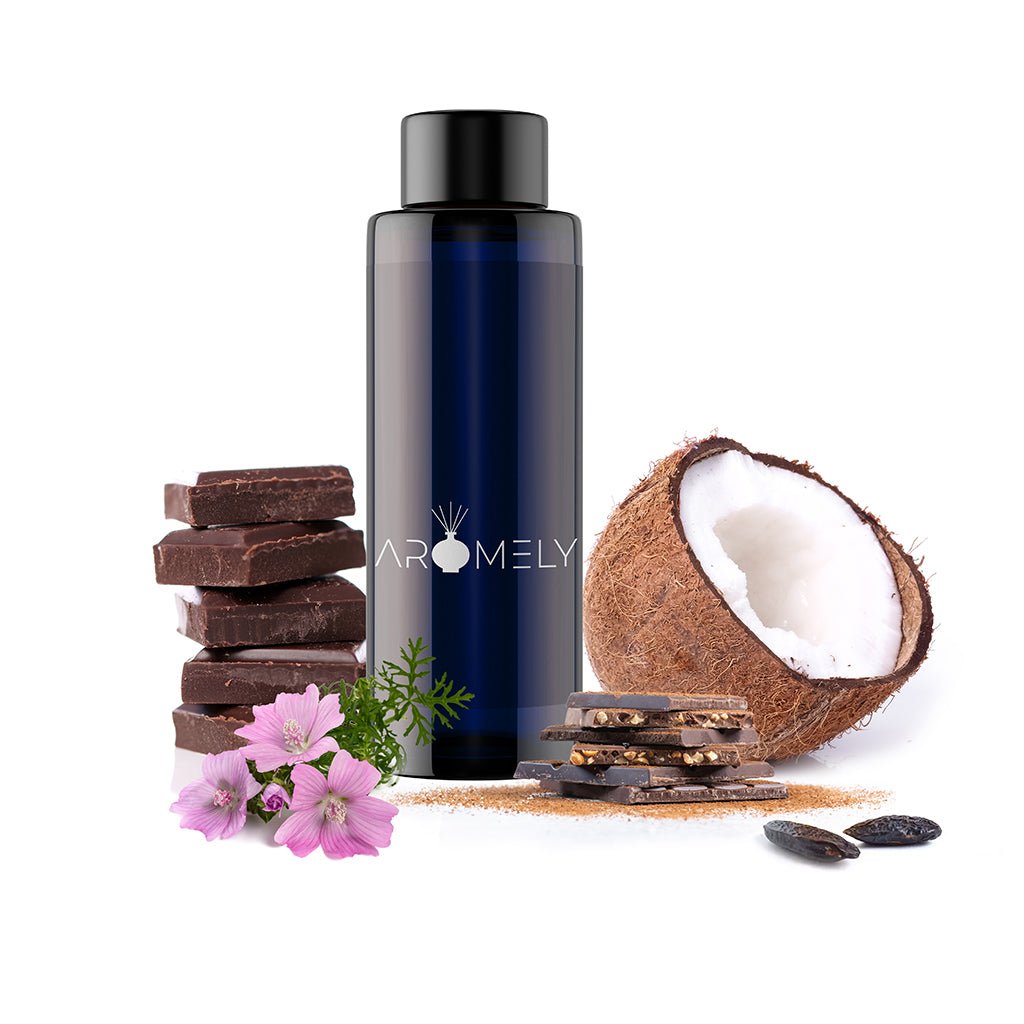 A dark blue AROMELY bottle labeled "Dark Chocolate" sits beside stacked chocolate, a halved coconut, flowers, and seeds on a white background, highlighting the rich essence of cocoa.