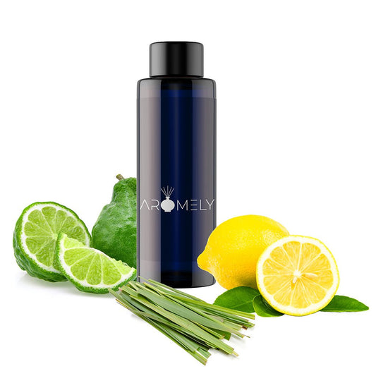 A dark blue AROMELY bottle labeled "Magnetic Seduction – Inspired by: W Hotel®" sits on a white background, surrounded by sliced lime, lemon, and lemongrass, evoking a long-lasting fragrance experience.