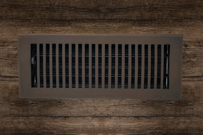 The Madelyn Carter Cast Brass Contemporary Vent Cover in Oil Rubbed Bronze features vertical slats and adds a sleek, modern touch to dark wood floors while ensuring efficient air circulation.