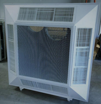 The EP Custom Four Way Angled Face Concentric Diffuser, a large white metal HVAC grille with multi-mesh panels, stands upright on a concrete floor in a dimly lit room.
