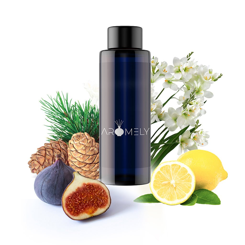 A dark blue AROMELY bottle labeled "St. Tropez - Inspired by: Edition Hotel®" is surrounded by pinecones, fig, lemon, white flowers, and pine needles on a white background.